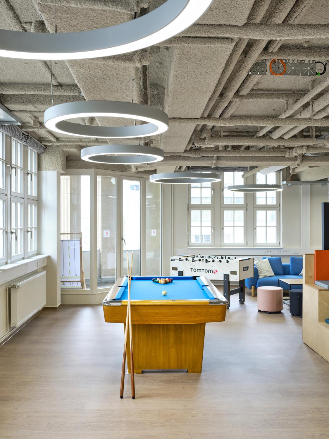 Game room with pool table and circular acoustic ceiling panels