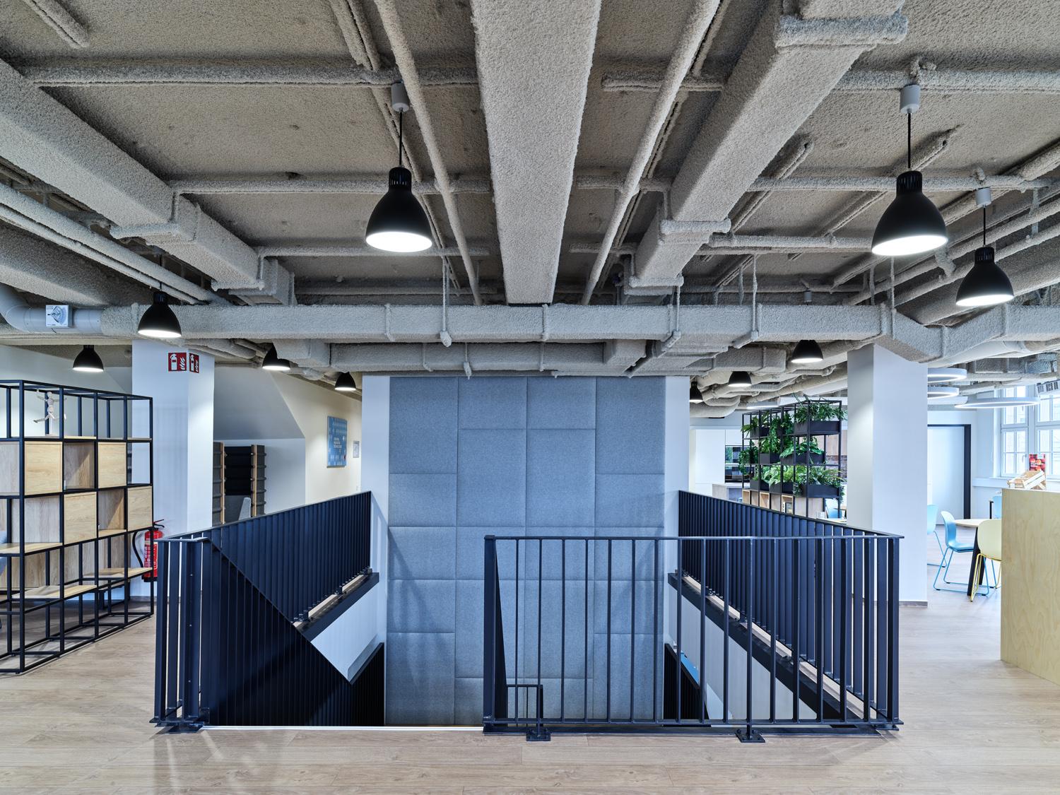 Open office space with acoustic panels installed around a central column